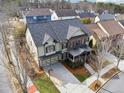 Aerial view of a well-maintained two-story home with a front-facing garage and a landscaped yard at 4492 Arbor Crest Ct, Suwanee, GA 30024