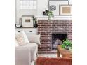 Close-up of a classic brick fireplace with decorative accents in a cozy living room at 462 Kendrick Se Ave, Atlanta, GA 30315