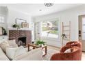 Cozy living room with a brick fireplace, hardwood floors, and natural light at 462 Kendrick Se Ave, Atlanta, GA 30315