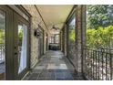 Covered porch featuring brick columns, slate tile flooring, ceiling fan, and comfortable seating, perfect for outdoor living at 1260 Monroe Ne Dr, Atlanta, GA 30306