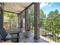 Inviting outdoor porch with stone columns, stylish furniture, and lush greenery, ideal for relaxation and enjoying views at 1260 Monroe Ne Dr, Atlanta, GA 30306