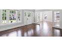 Bright living room featuring hardwood floors, neutral paint, and an open doorway at 1585 Olympian Sw Cir, Atlanta, GA 30310