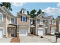 Attractive townhomes featuring neutral exteriors, single-car garages, and well-maintained landscaping at 2130 Executive Dr, Duluth, GA 30096