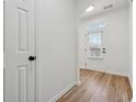 Bright hallway boasting hardwood floors and a white door leading to the backyard at 2130 Executive Dr, Duluth, GA 30096