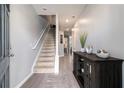 Inviting entryway with neutral walls, stairs, wood-look floors, and console table at 5696 Union Pointe Dr, Union City, GA 30291