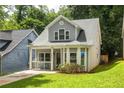 Inviting two-story home with gray siding, manicured lawn, and charming curb appeal at 1296 Plaza Sw Ave, Atlanta, GA 30310