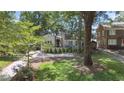 Charming home featuring a landscaped front yard, awning-covered porch, and a long driveway at 1423 Briarcliff Ne Rd, Atlanta, GA 30306