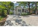 Charming home featuring a long driveway, manicured front yard and decorative accents at 1423 Briarcliff Ne Rd, Atlanta, GA 30306