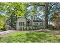 Charming home featuring a landscaped front yard, awning-covered porch, and a long driveway at 1423 Briarcliff Ne Rd, Atlanta, GA 30306
