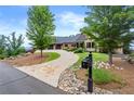 Long, stone-trimmed driveway leading to a gorgeous home surrounded by beautiful landscaping at 49 Waterside Se Dr, Cartersville, GA 30121