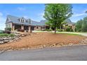 Charming exterior featuring a three-car garage, lush landscaping, and manicured lawn at 49 Waterside Se Dr, Cartersville, GA 30121