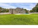 Spacious backyard with an in-ground pool, a light gray home exterior, and a white fence at 1197 Kenilworth Trce Trce, Snellville, GA 30078