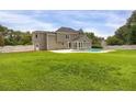 Expansive backyard featuring an in-ground pool and privacy fence, ideal for outdoor entertaining and relaxation at 1197 Kenilworth Trce Trce, Snellville, GA 30078