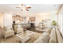 Bright, open-concept living space with hardwood floors, stylish furniture, and seamless flow to the kitchen at 1247 Winterhaven Dr, Cumming, GA 30041