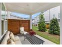 Cozy covered patio with outdoor seating and privacy screen, perfect for relaxing and entertaining at 1247 Winterhaven Dr, Cumming, GA 30041