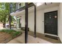 Charming front entrance with a covered porch and a secure-looking black door at 1445 Monroe Ne Dr # 14B, Atlanta, GA 30324