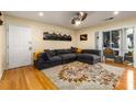 Bright living room featuring a plush grey sofa, a stylish rug, and an open doorway to the outdoor patio at 1445 Monroe Ne Dr # 14B, Atlanta, GA 30324