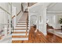 Elegant foyer with hardwood floors, staircase with iron railing, and access to formal living spaces at 2165 Parkview Nw Run, Atlanta, GA 30318