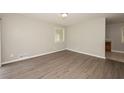 Open-concept living room features new laminate flooring, light gray walls and ample natural light at 1112 Evelyn Drive Dr, Forest Park, GA 30297