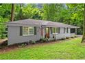 Charming single-story home featuring a classic brick facade, white picket fence, and an inviting carport at 269 Terrydale Se Dr, Marietta, GA 30067