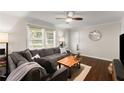 Cozy living room features a large sectional, hardwood floors, and natural light from the window at 269 Terrydale Se Dr, Marietta, GA 30067