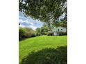 Large grassy backyard offering ample space for outdoor activities, bordered by mature trees and greenery at 3400 Elm Creek Nw Dr, Marietta, GA 30064