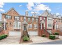 Well-maintained townhomes showcasing brick and stone facades, attached garages, and inviting curb appeal at 10775 Brunson Dr, Johns Creek, GA 30097