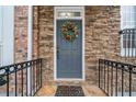 Attractive front door with a decorative wreath and stone accents for a welcoming entrance at 10775 Brunson Dr, Johns Creek, GA 30097