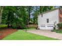 Spacious backyard with two-car garage, lush lawn, basketball court and stairs leading up at 1209 Colony Cir, Marietta, GA 30068