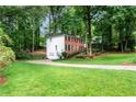 Well-manicured lawn and landscaping surround this traditional brick home with a two-car garage at 1209 Colony Cir, Marietta, GA 30068