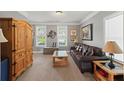 Inviting living room with a leather sofa, wooden furniture, and a decorative Gathering tree art piece at 110 Ashbury Circle Cir, Dallas, GA 30157