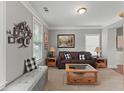 Cozy living room featuring a leather sofa, decorative wall art, and natural light from windows at 110 Ashbury Circle Cir, Dallas, GA 30157