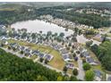 Aerial view of the neighborhood with lake view, lush trees and well-maintained homes at 11833 Spring Lake Way, Fayetteville, GA 30215