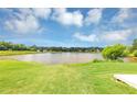Scenic view of a serene lake surrounded by lush greenery, offering a peaceful and picturesque setting at 11833 Spring Lake Way, Fayetteville, GA 30215