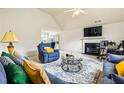 Bright living room with vaulted ceiling, plush sofas, and a cozy fireplace at 11833 Spring Lake Way, Fayetteville, GA 30215