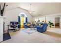 Spacious living room with high ceilings, neutral carpet, and a large window showcasing natural light at 11833 Spring Lake Way, Fayetteville, GA 30215
