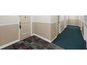 Neutral hallway with tile entry and carpeting leading to resident doors at 6851 Roswell Rd # 15, Atlanta, GA 30328
