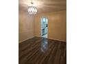 Room with wood flooring and dining area leading to the kitchen at 6851 Roswell Rd # 15, Atlanta, GA 30328
