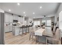 Open-concept kitchen with a large island, stainless steel appliances, and a seamless flow to the dining area at 1542 Villageside Ct, Lawrenceville, GA 30043
