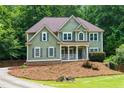 Inviting two-story home with a covered porch, traditional windows, and a beautifully landscaped front yard at 5741 Stonekirk Walk Northwest, Acworth, GA 30101
