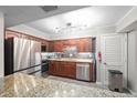 Modern kitchen featuring stainless steel appliances, granite countertops, and ample cabinet space at 834 Lake Hollow Sw Blvd, Marietta, GA 30064