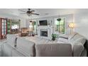 Cozy living room featuring a brick fireplace, lots of natural light, and hardwood floors at 834 Lake Hollow Sw Blvd, Marietta, GA 30064