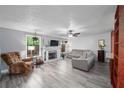 Bright living room with a fireplace, hardwood floors, and a ceiling fan for comfort at 834 Lake Hollow Sw Blvd, Marietta, GA 30064
