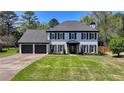 Charming two-story home with painted brick, black shutters, and a well-manicured lawn at 1807 N Chestnut Grove Dr, Marietta, GA 30066