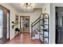 Inviting foyer featuring hardwood floors, modern lighting, staircase, and decorative shelving at 1807 N Chestnut Grove Dr, Marietta, GA 30066