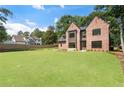 Beautifully landscaped yard complements this brick home, complete with modern architectural details at 3711 Mountain Cove Rd, Snellville, GA 30039