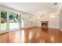 Spacious living room with hardwood floors, fireplace, and French doors leading to the backyard at 3711 Mountain Cove Rd, Snellville, GA 30039