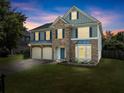 Charming two-story home featuring a stone facade, two-car garage, manicured lawn, and classic curb appeal at 5420 Stevehaven Ln, Cumming, GA 30028