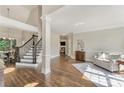 Inviting foyer with hardwood floors, elegant staircase, and bright natural light at 6630 Club Valley Ct, Suwanee, GA 30024