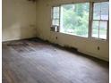Empty living room featuring hardwood floors, large windows providing natural light, and neutral wall colors at 1159 Eastridge Sw Rd, Atlanta, GA 30311